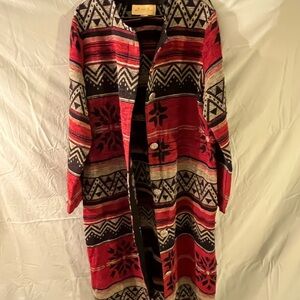 This is a vintage New Frontier red and black patterned cardigan
